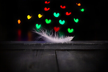 wooden dark background with a white pen and a brightly colored bokeh