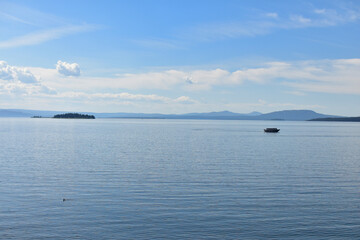 Obraz premium Lone Boater on Yellowstone Lake by Yellowstone Lake Lodge- Yellowstone National Park Wyoming