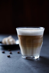 Coffee with milk on dark stone background. Close up.	