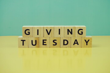 Giving Tuesday alphabet letter on green and yellow background
