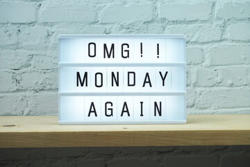 Monday Again word in light box on wooden background