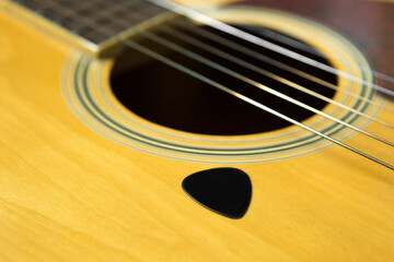 Selective focus of Pick on Acoustic guitar  and copy space