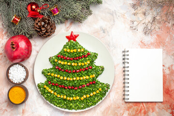 top view tasty green salad in new year tree shape with seasonings on a light background holiday meal health xmas color photo