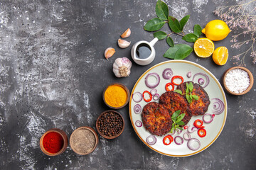 top view delicious cutlets with onion rings on grey floor dish cuisine meal meat