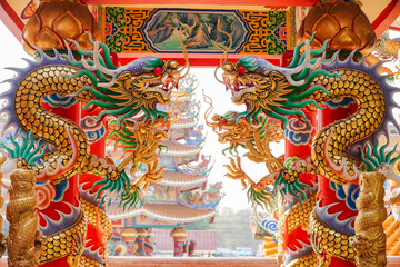 Colorful statue of Chinese dragon wrapped around the pillar. Beautiful statue of dragon carved...