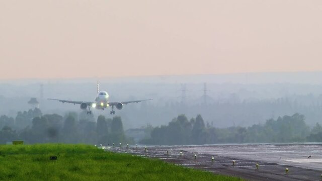 Airplane landing on the runway. A320 on final approach for landing.4K