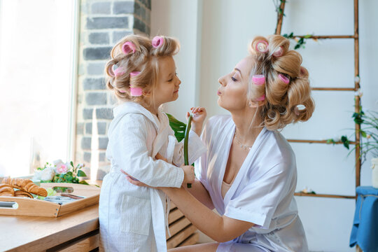 Funny Mom And Daughter In Curlers Play