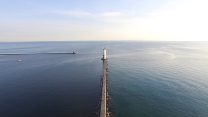 drone view of a lighthouse on a breakwater