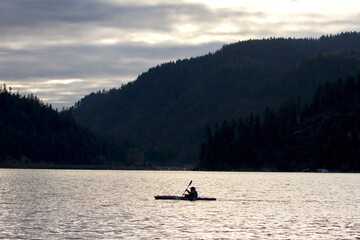 Lone kayaker on a calm lake.