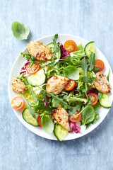 Salad with Chicken Breast, Cherry Tomatoes, Cucumber, Rocket and fresh Basil. Bright wooden background. Top view. Close up. 