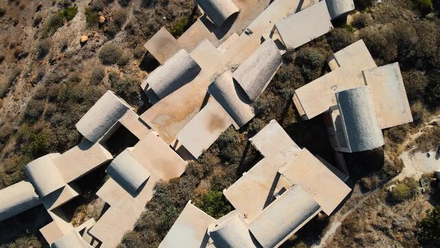 Aerial top down shot of an unfinished house complex on the coast of Santorini
