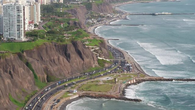 Aerial view of the green coast highway and buildings of  Miraflores district with view of the pacific ocean, in Lima, Peru