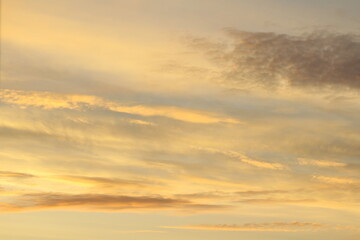 Sun below the horizon and clouds in the fiery dramatic orange sky at sunset or dawn backlit by the sun. Place for text and design