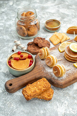 Simple pancakes with lemons on cutting board and cookies honey on blue background stock image