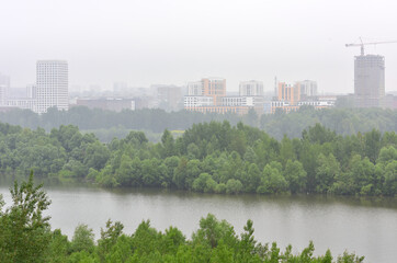 New multi-storey residential buildings of modern architecture in the fog on the banks of the Ob...