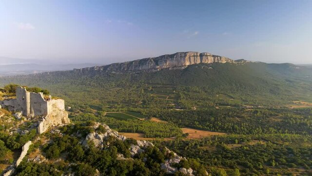 Aerial shots of the Castle of Montferrand (12th century) at the top of the mountain. We can see the Pic Saint Loup, the Hortus and the village of Saint Mathieu de Treviers in the southeast of France.