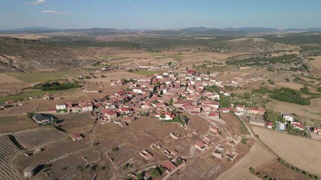 Aerial shots of Fuentelsaz, beautiful and typical village of Castilla-La Mancha, land of Don Quixote. Around it we can see a ruined castle from the 11th century, wind mills, a cemetery, agriculture...