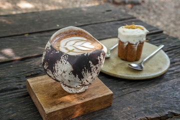 selective focus hot mocha in craft handmade cup with carrot cake