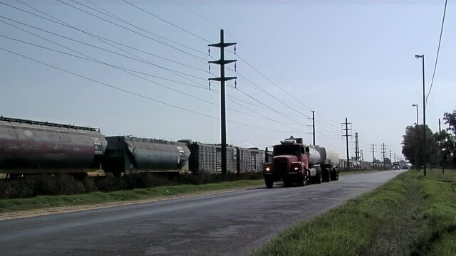 Cargo Train and Truck on Rural Road in Santa Fe province, Argentina. 
