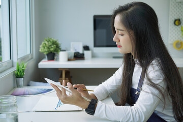 Female Artist painting on canvas at home. Hobby and leisure concept.