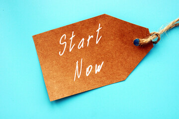 Business concept meaning Start Now with inscription on the piece of paper.