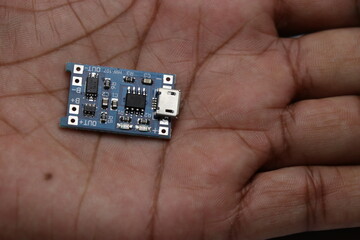 TP 4056 charging module held in hand. Lithium ion battery charging board