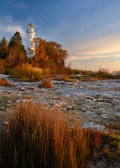 Cana Island Light is seen just after dawn in October with fall colors shinning almost as bright as...