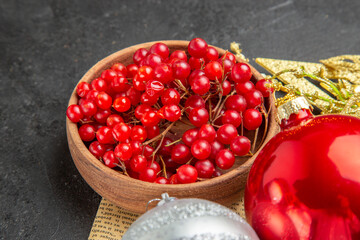 front view red cranberries with christmas tree toys on dark background berry fruit color photo
