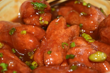Crispy sausages mixed with tomato sauce, scallions, vegetables and spices, sweet and fragrant, a snack for children or families.