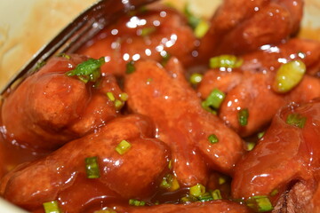 Crispy sausages mixed with tomato sauce, scallions, vegetables and spices, sweet and fragrant, a snack for children or families.