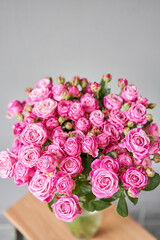 pink rose branch in a vase . Summer background. Bouquet of roses present for Mothers Day. Photo of Flowers for a catalog of flower online store and delivery.
