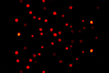 Naklejka na ściany i meble Red glitter vintage lights background. defocused. black background
