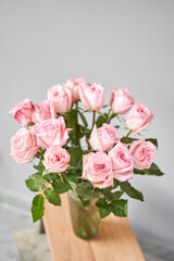 pink rose in a vase . Summer background. Bouquet of roses present for Mothers Day. Photo of Flowers for a catalog of flower online store and delivery.