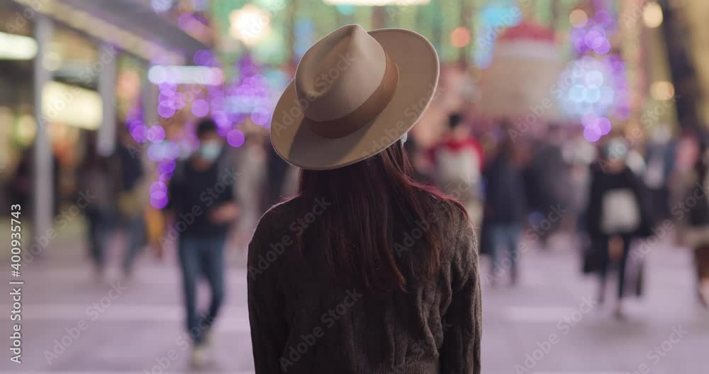 Canvas Prints Woman look at the Christmas decoration in city at night