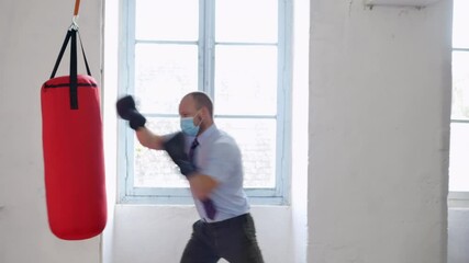 Professional businessmen suit: shirt and neck tie and boxing gloves hitting heavy bag. professional competition and success posture, sport conflict fight knockout concept. Business training. - Powered by Adobe