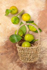 top view fresh green tangerines inside basket on light background photo color mellow fruit juice