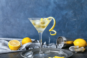 Glass of fresh martini on color background