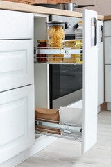 Glass jars with products on shelf in drawer