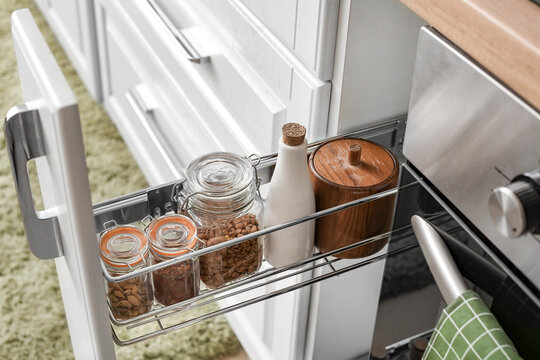 Glass jars with products on shelf in drawer
