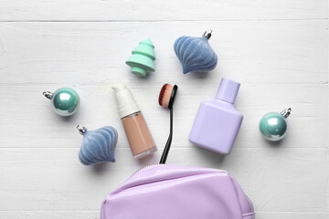 Christmas composition with cosmetics on light background