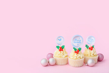 Tasty Christmas cupcakes on color background
