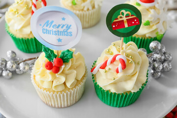 Dessert stand with tasty Christmas cupcakes, closeup
