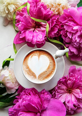Pink peony flowers and cup of coffee