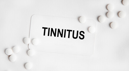 On the card text TINNITUS , next to the white tablets.