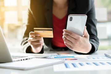 Online Payments Man's hands hold a smartphone and use credit cards to shop online, article websites, blogs, e-commerce sites.