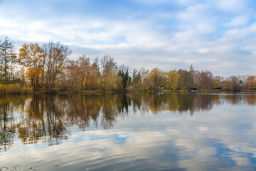 Panorama with reflections in the water at the Grube Fernie in Grossen-Linden close to Giessen, Germany