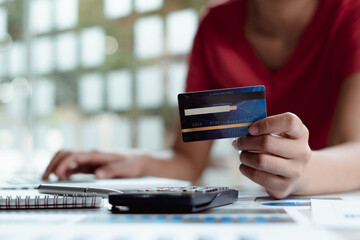 person holding card and laptop