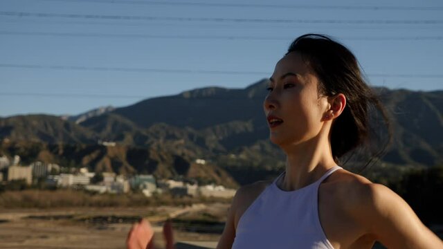 Attractive asian woman going for her morning run in a park in Los Angeles