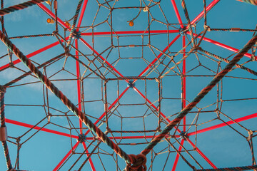 Abstract geometrical background photo of colorful ropes on blue sky background