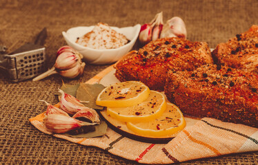 Pieces of salted meat with lemon, garlic and spices. Cooking a meat dish